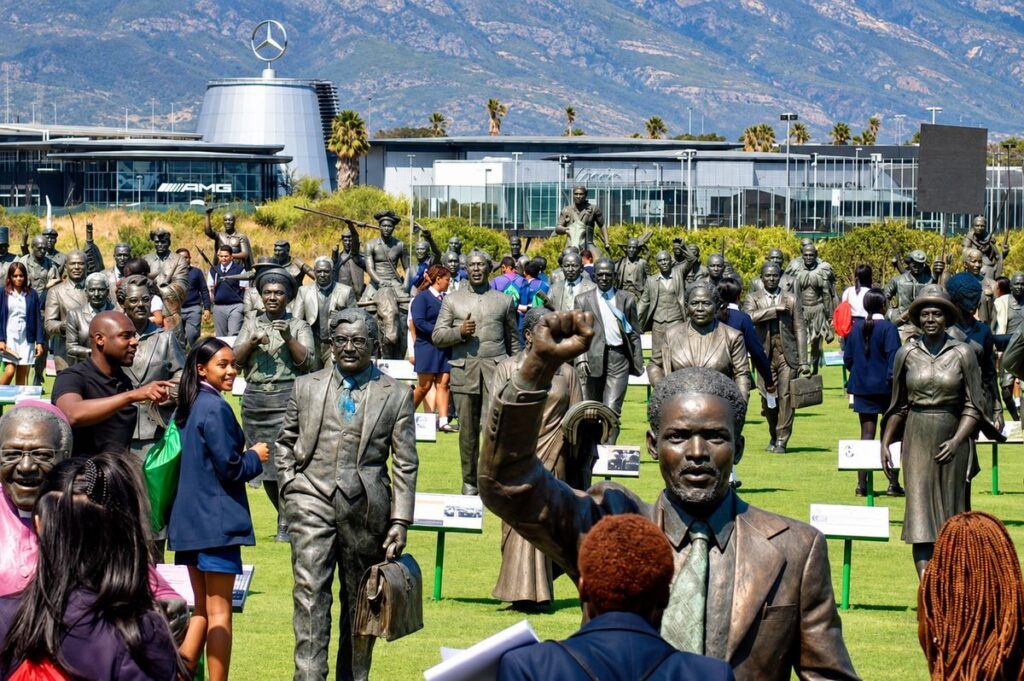 School learners exploring the bronze statues